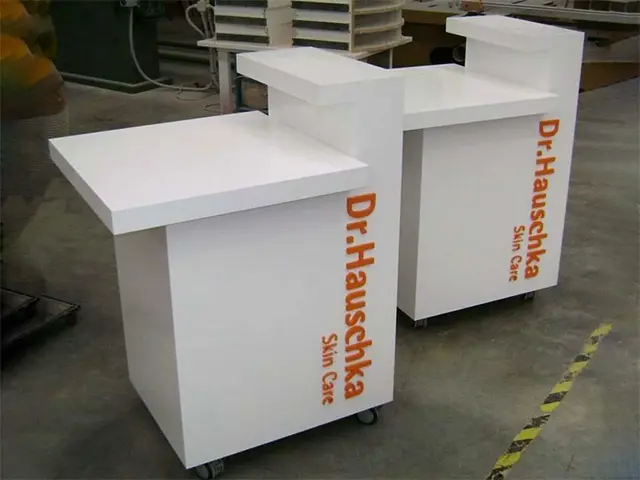 White Dr.Hauschka Skin Care counters on castors with orange branding down the side panels