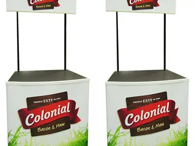 Two Colonial Bacon & Ham counters with grass-printed fronts and raised headers