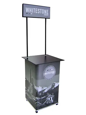 Whitestone Cheese counter on wheels with a twin-pole header and mountain village wrap