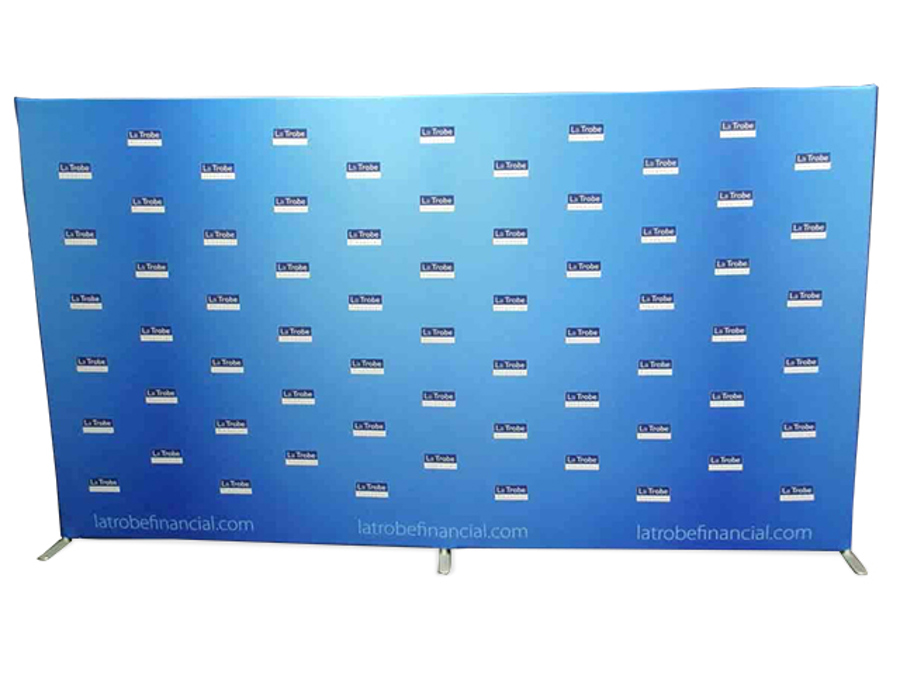 Freestanding blue step-and-repeat media wall printed with rows of La Trobe Financial logos and the company web address