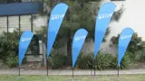 Outdoor flags in alternating heights along a verge