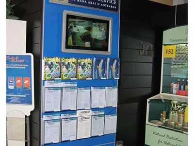 New Zealand Customs Service brochure display with a screen above rows of clear leaflet pockets