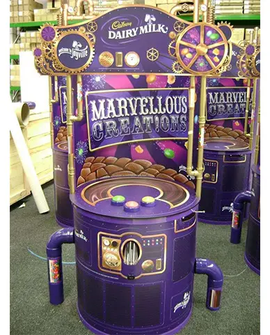 Cadbury Marvellous Creations game machine with cogs, gauges, pipes and three push buttons
