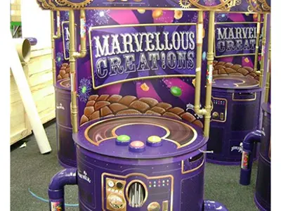 Cadbury Marvellous Creations game machine with cogs, gauges, pipes and three push buttons