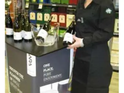ARA wines demo table with open bottles and an ice bucket in a liquor store